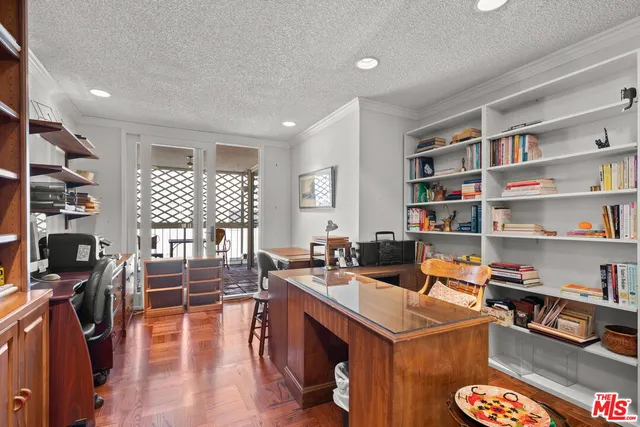 a living room with furniture and a book shelf