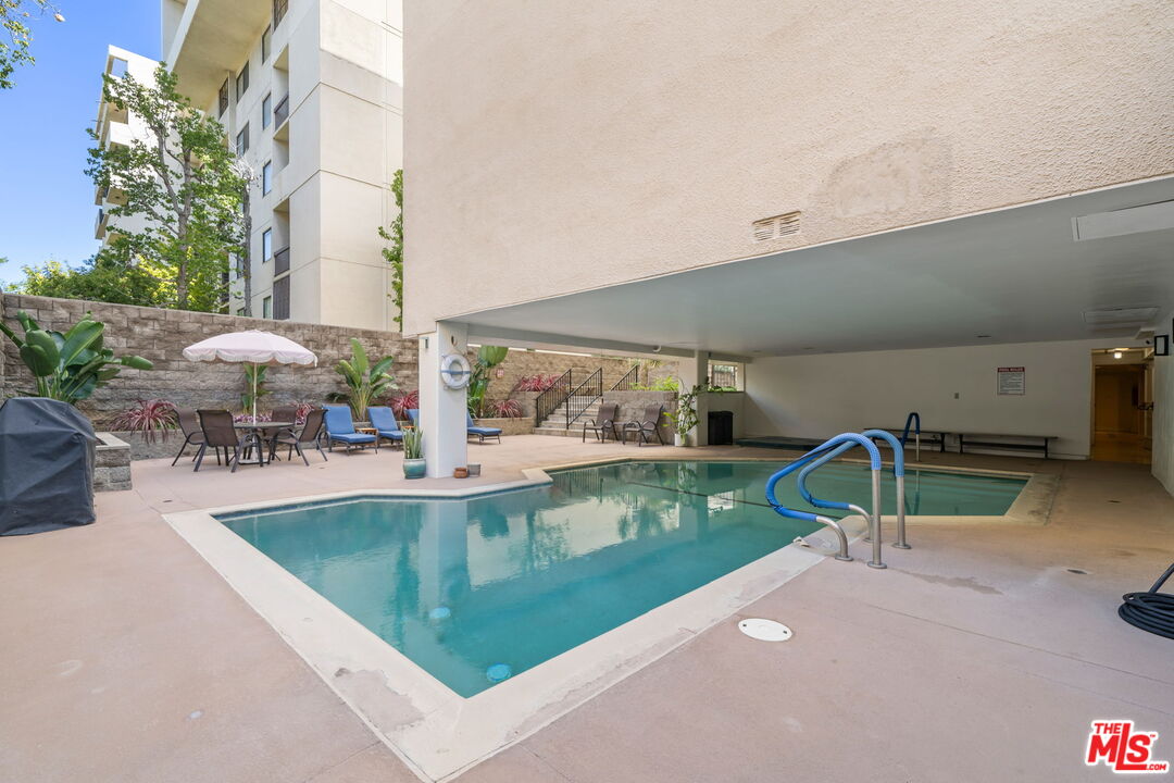 321 North Oakhurst Drive, Unit 403 Beverly Hills, CA 90210 - Photo 26 of 42 an outdoor space with swimming pool and furniture