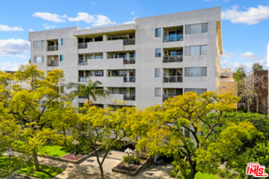 321 North Oakhurst Drive, Unit 403 Beverly Hills, CA 90210 - Photo 32 of 42 a building view with a garden space