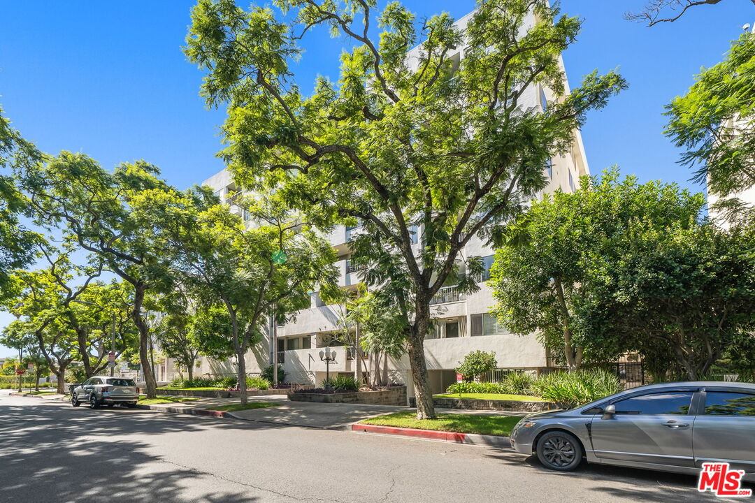 321 North Oakhurst Drive, Unit 403 Beverly Hills, CA 90210 - Photo 37 of 42 a car parked in front of a building