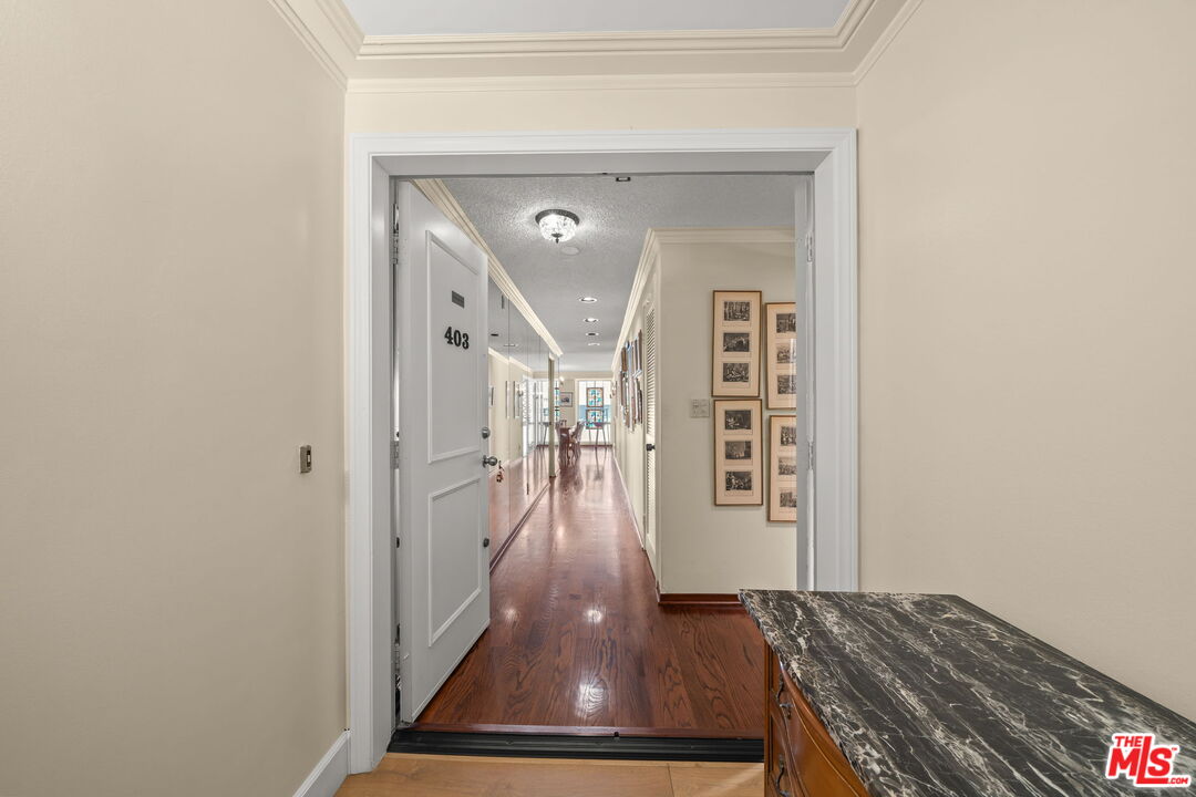 321 North Oakhurst Drive, Unit 403 Beverly Hills, CA 90210 - Photo 4 of 42 a view of a hallway with wooden floor and stairs
