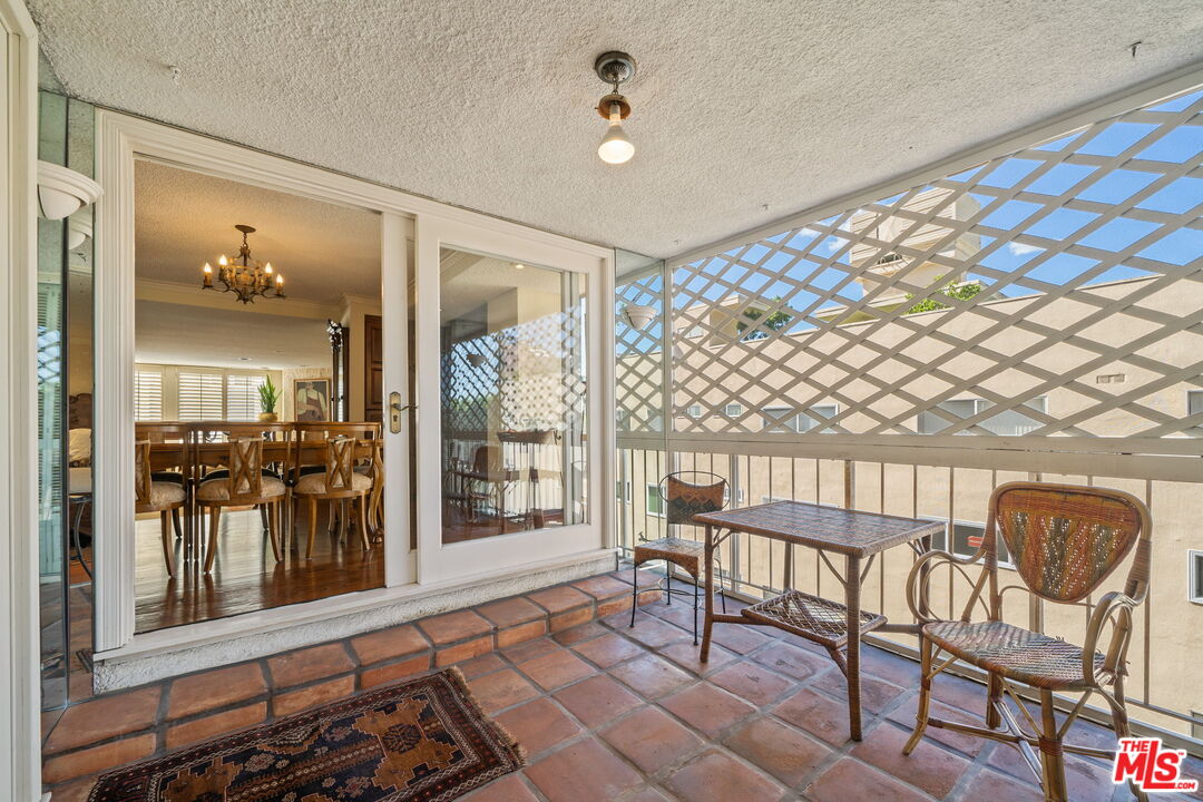 321 North Oakhurst Drive, Unit 403 Beverly Hills, CA 90210 - Photo 9 of 42 a view of a porch with a table and chairs