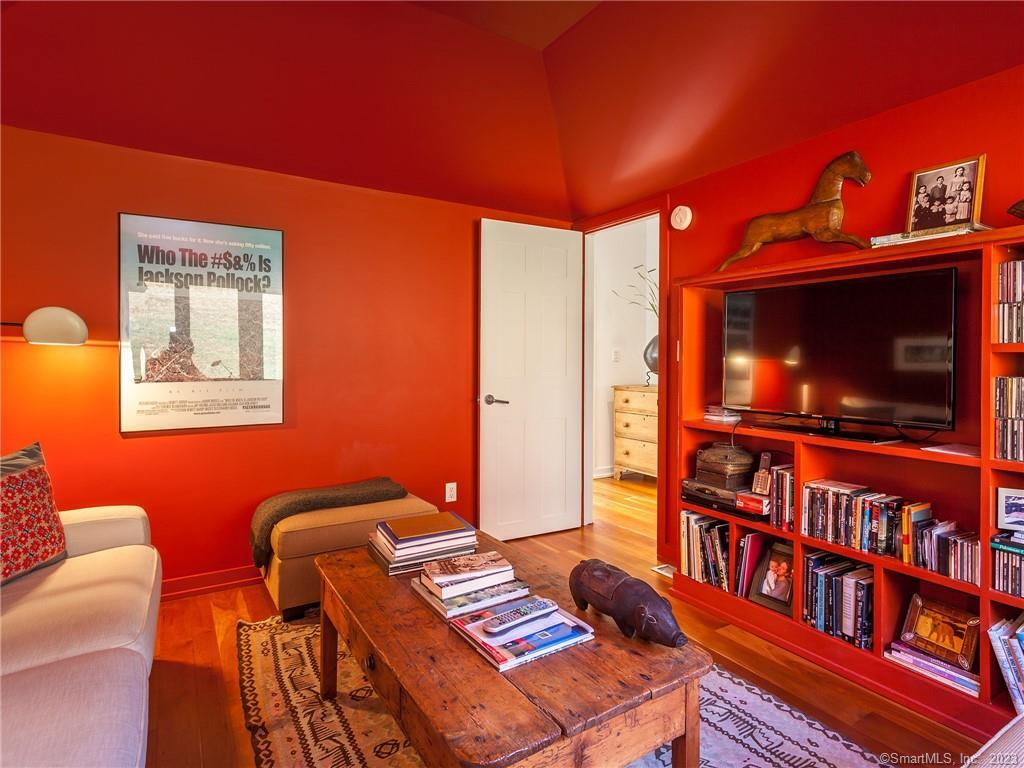 151 Treasure Hill Road Kent, CT 06785 - Photo 16 of 25 a living room with furniture a flat screen tv and a bookshelf