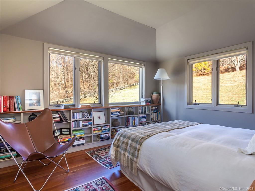 151 Treasure Hill Road Kent, CT 06785 - Photo 19 of 25 a bed room with a bed and a chair