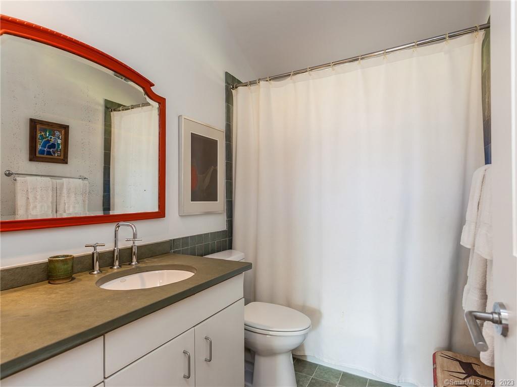 151 Treasure Hill Road Kent, CT 06785 - Photo 20 of 25 a bathroom with a granite countertop sink and a mirror