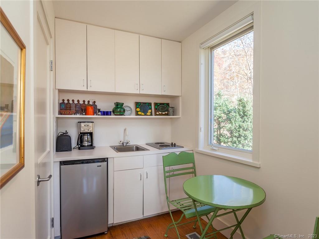 151 Treasure Hill Road Kent, CT 06785 - Photo 24 of 25 a room with a cabinets a sink and a window