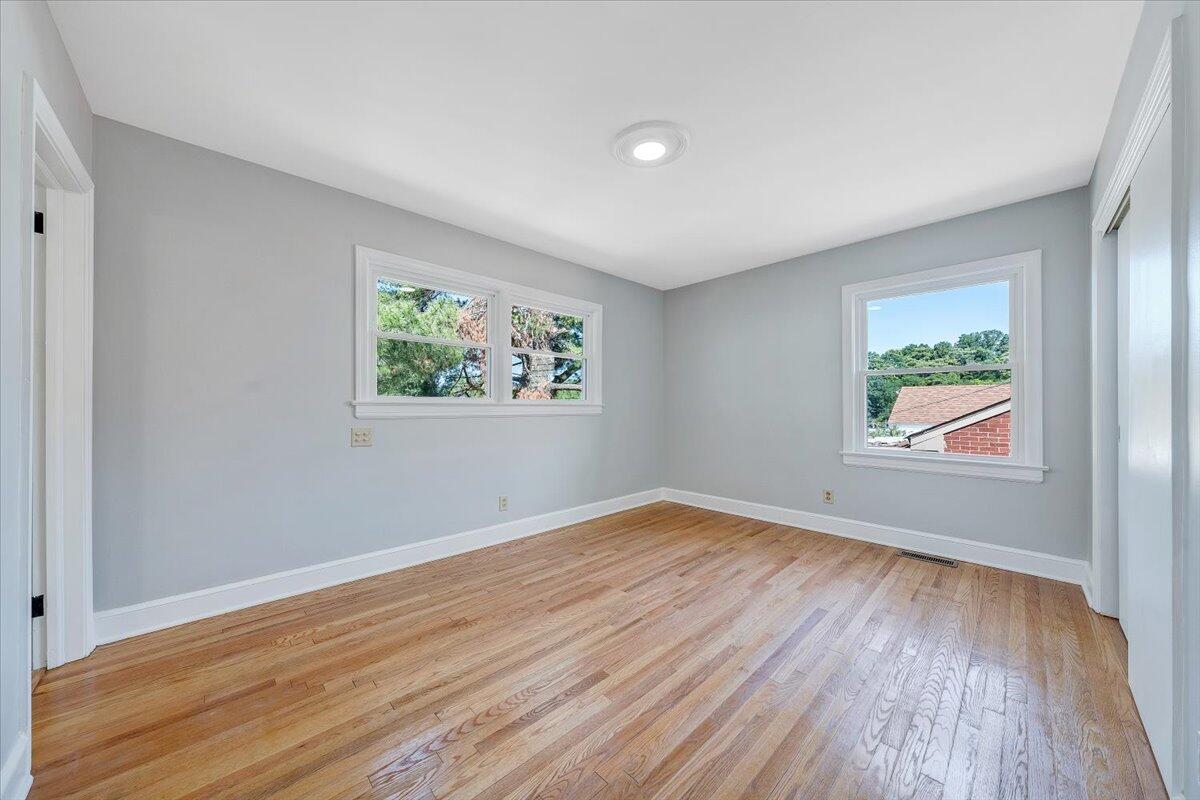547 Dillard Road Southwest Roanoke, VA 24014 - Photo 17 of 26 an empty room with wooden floor and window