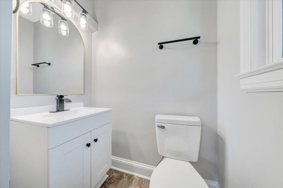 547 Dillard Road Southwest Roanoke, VA 24014 - Photo 20 of 26 a bathroom with a toilet a sink and mirror