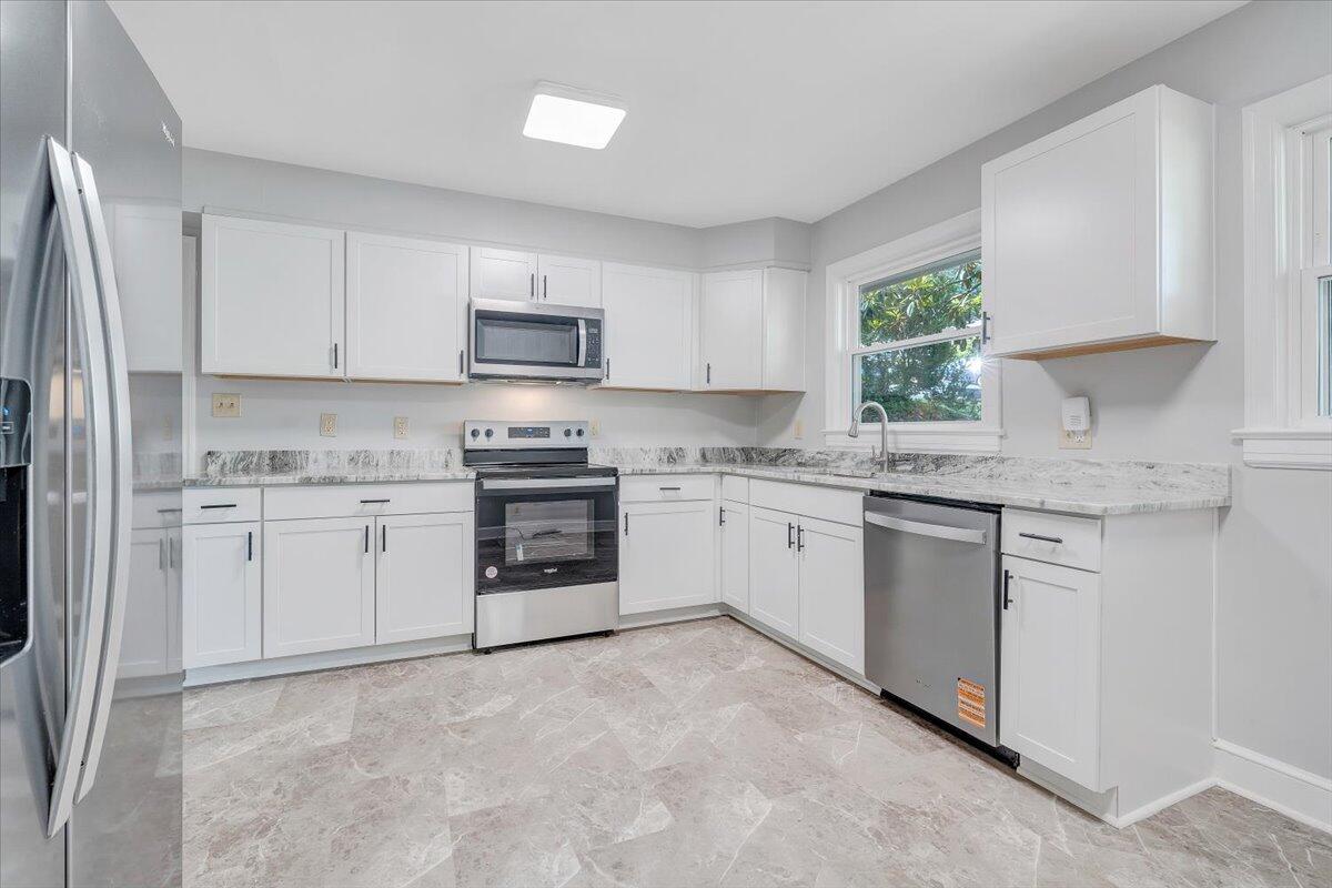 547 Dillard Road Southwest Roanoke, VA 24014 - Photo 4 of 26 a kitchen with granite countertop white cabinets and white stainless steel appliances