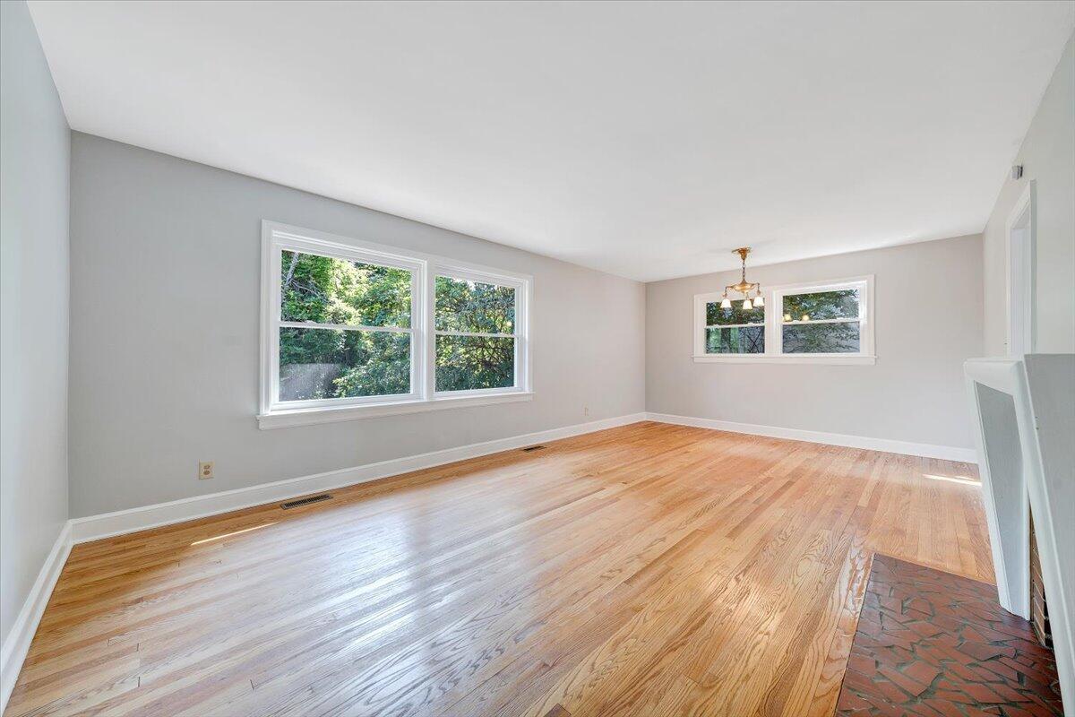 547 Dillard Road Southwest Roanoke, VA 24014 - Photo 8 of 26 a view of an empty room with wooden floor and a window