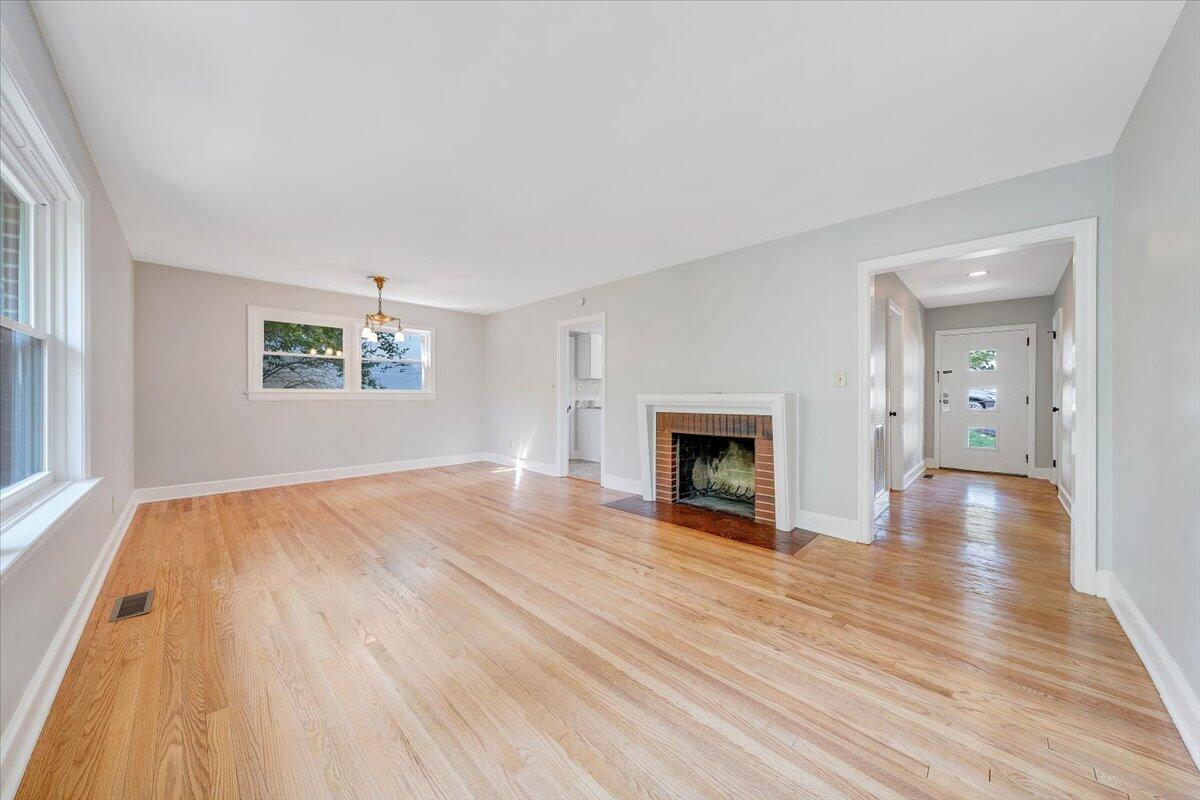 547 Dillard Road Southwest Roanoke, VA 24014 - Photo 10 of 26 wooden floor fireplace and windows in an empty room