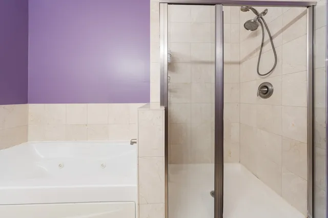 a bathroom with a bathtub and shower