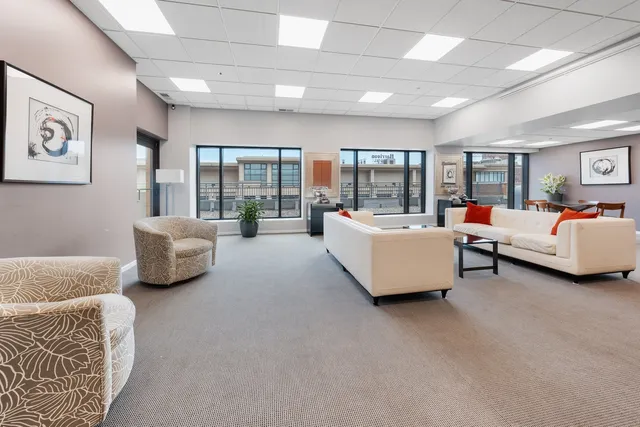 a bedroom with furniture and large windows