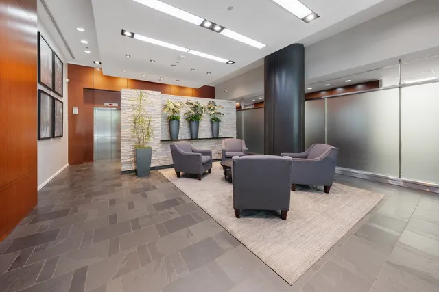 a lobby with furniture and a rug