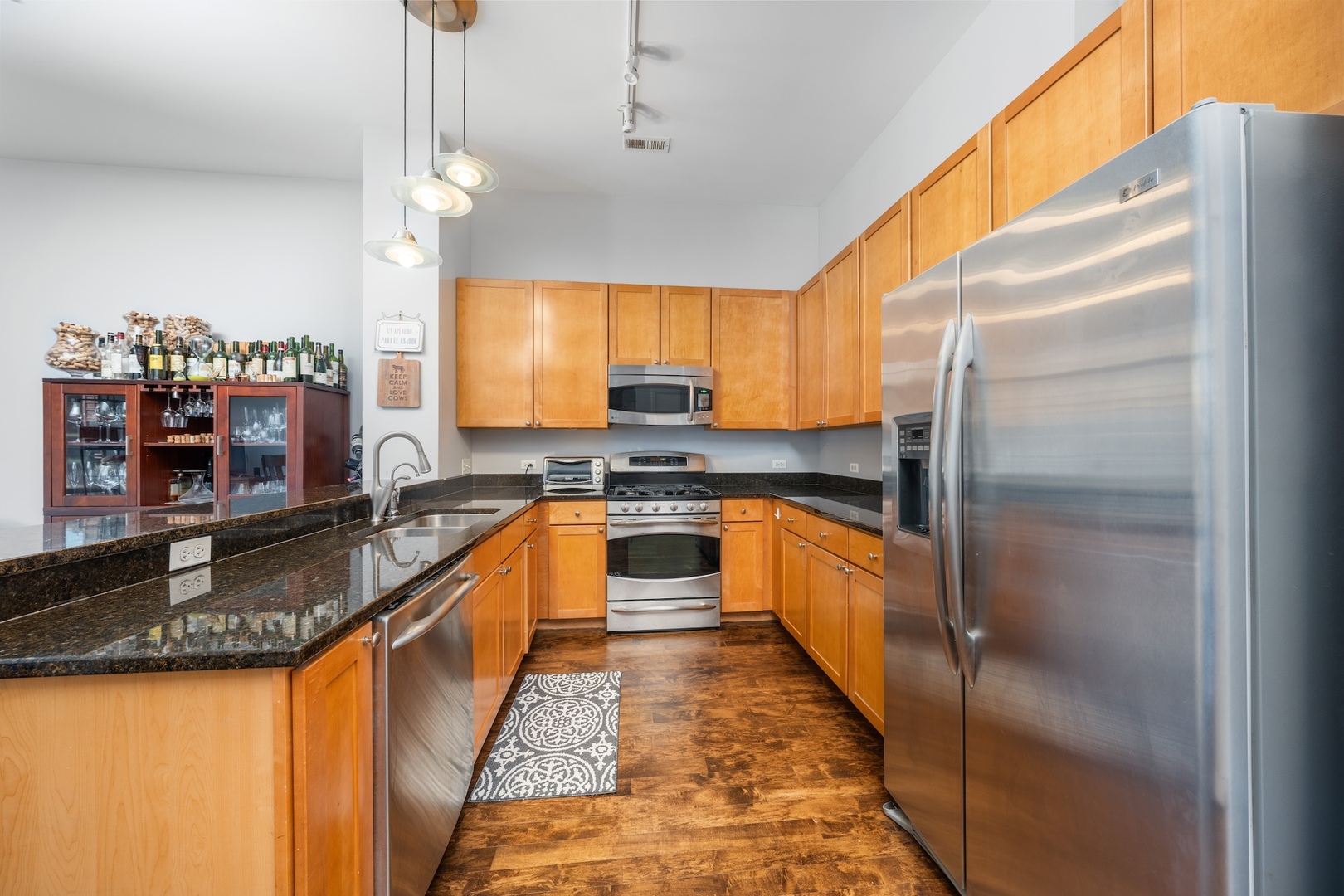 520 South State Street, Unit 1722 Chicago, IL 60605 - Photo 7 of 28 a large kitchen with granite countertop lots of counter top space and stainless steel appliances