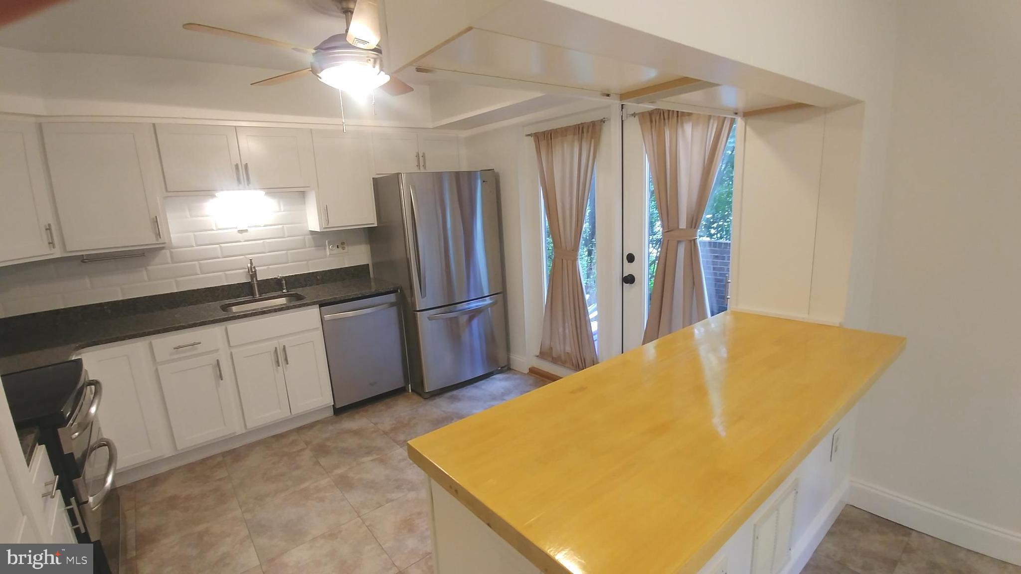 10740 Faulkner Ridge Circle Columbia, MD 21044 - Photo 7 of 26 Kitchen island with cabinets above and below.