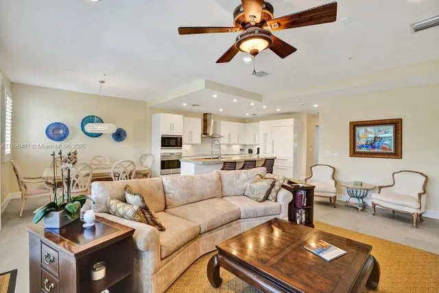 a dining room with furniture a chandelier and window