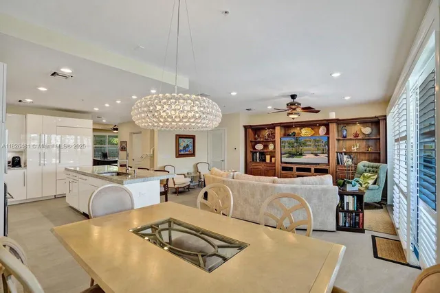 a hallway with two painting on the wall and a large window