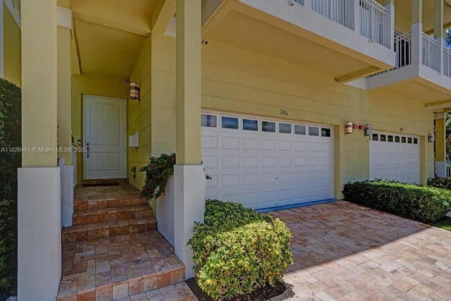 a view of a patio with couches dining table and chairs with wooden floor
