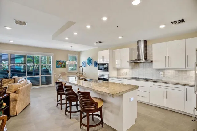 a living room with furniture a window and a flat screen tv