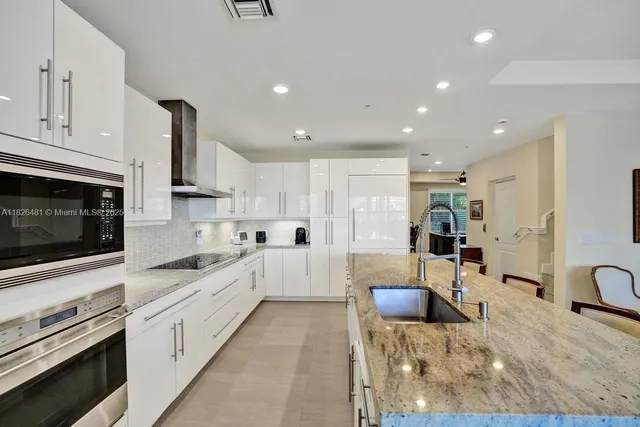 a living room with fireplace furniture and a chandelier