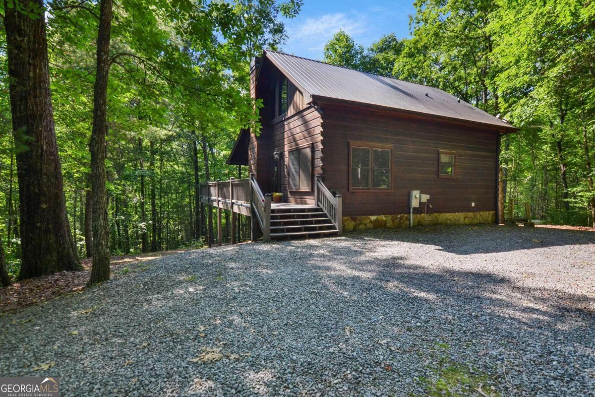 63 Bushy Head Road, Unit 1 Cherry Log, GA 30522 - Photo 1 of 1 a view of a house with a yard and large trees