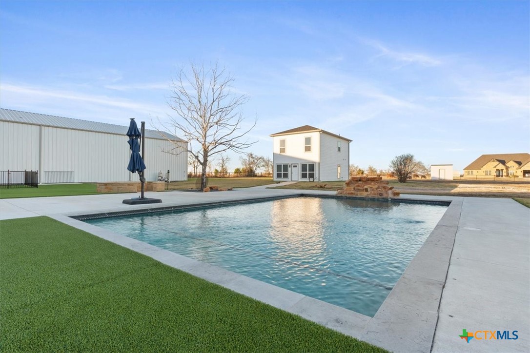 10940 Wedel Cemetery Road Rogers, TX 76569 - Photo 34 of 48 a view of a swimming pool with a lounge chair