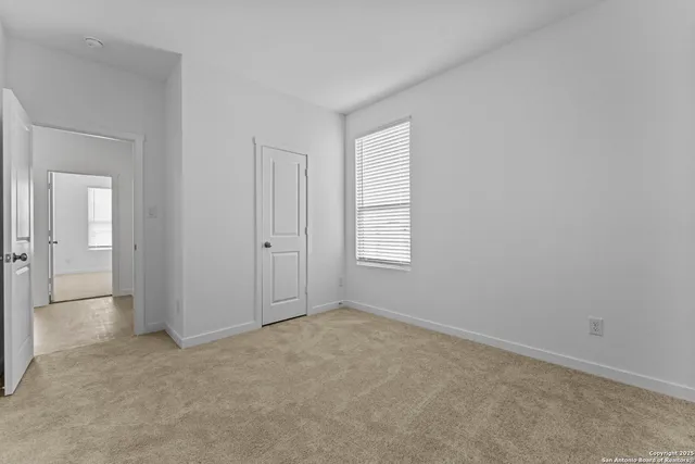 an empty room with windows and closet