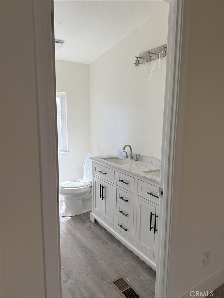 3835 Gardiner Ferry Road, Unit 98 Corning, CA 96021 - Photo 8 of 11 a view of bathroom with a toilet sink and mirror
