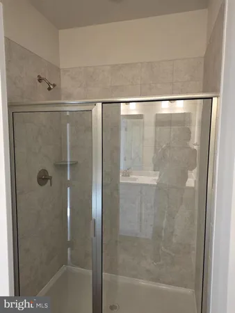 a bathroom with a glass shower door