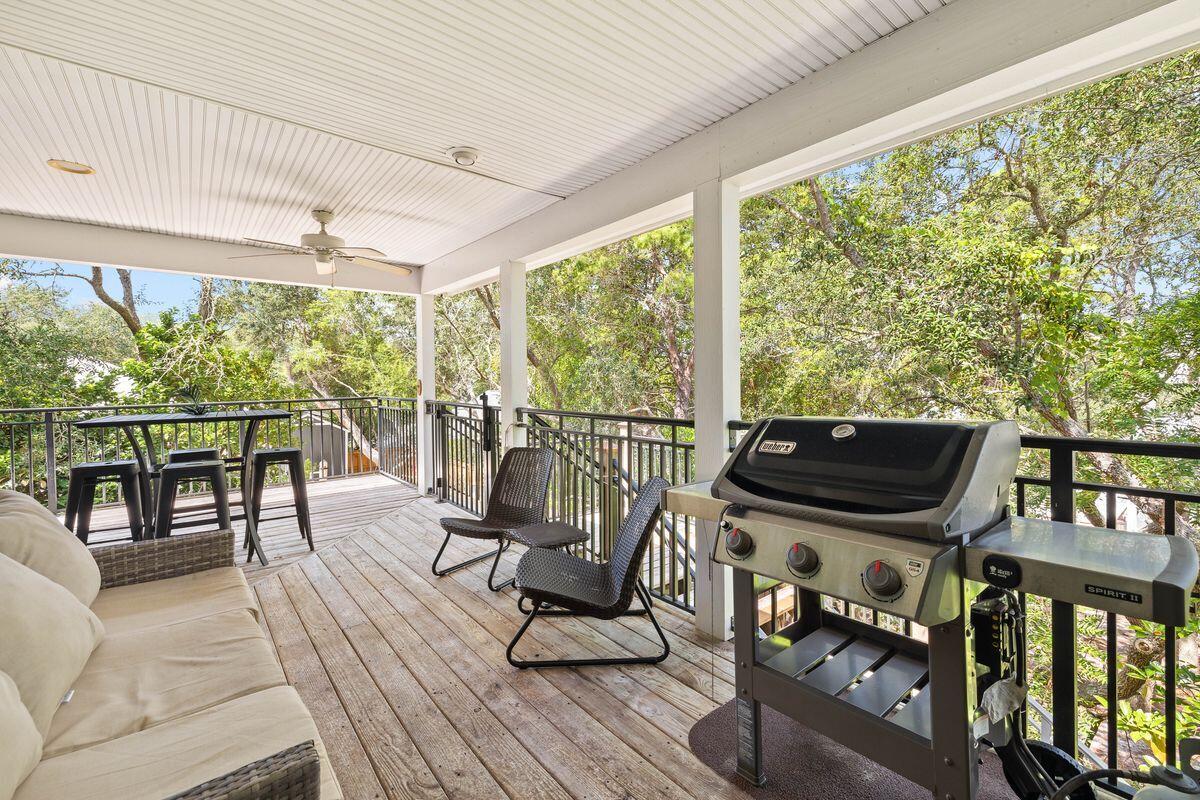 141 Crescent Road Santa Rosa Beach, FL 32459 - Photo 18 of 40 a view of a balcony with chairs and wooden floor