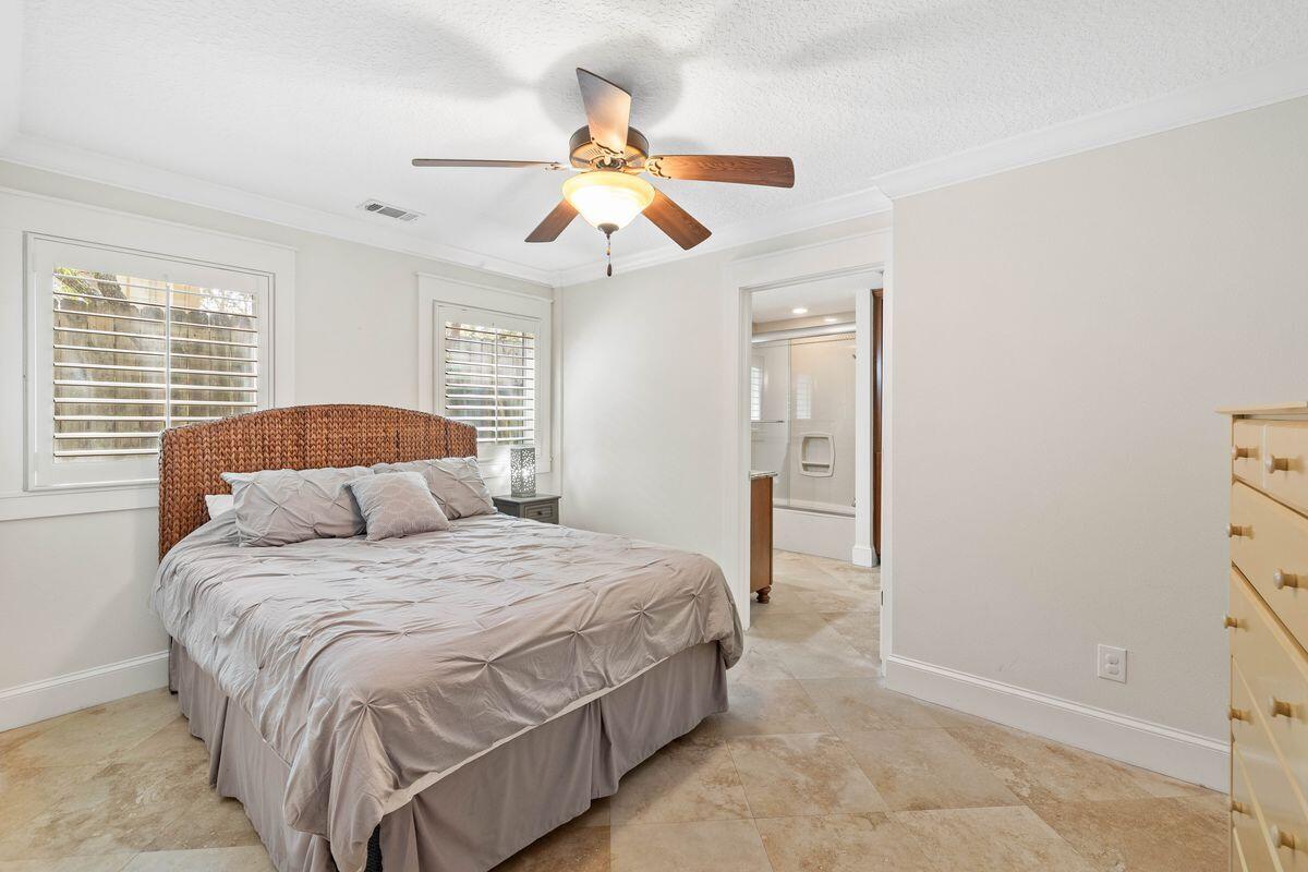 141 Crescent Road Santa Rosa Beach, FL 32459 - Photo 27 of 40 a bedroom with a bed and a chandelier