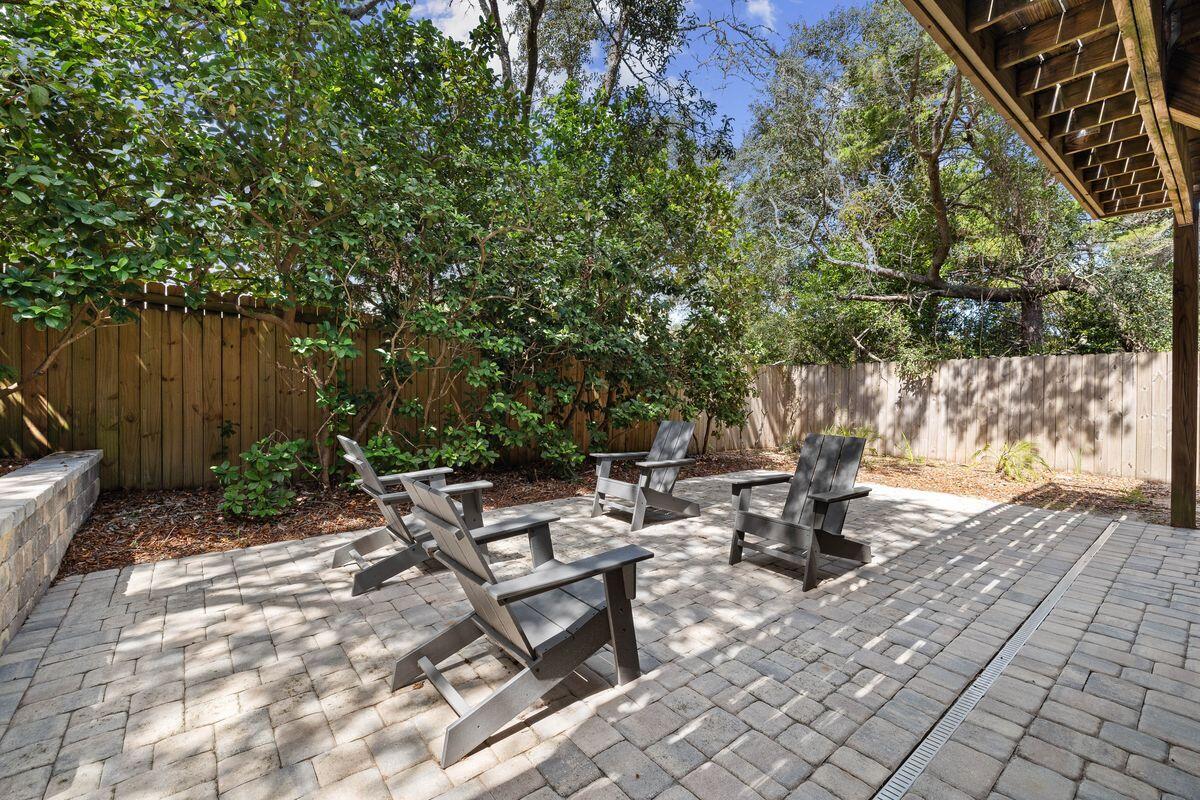 141 Crescent Road Santa Rosa Beach, FL 32459 - Photo 38 of 40 a view of backyard with a table and chairs