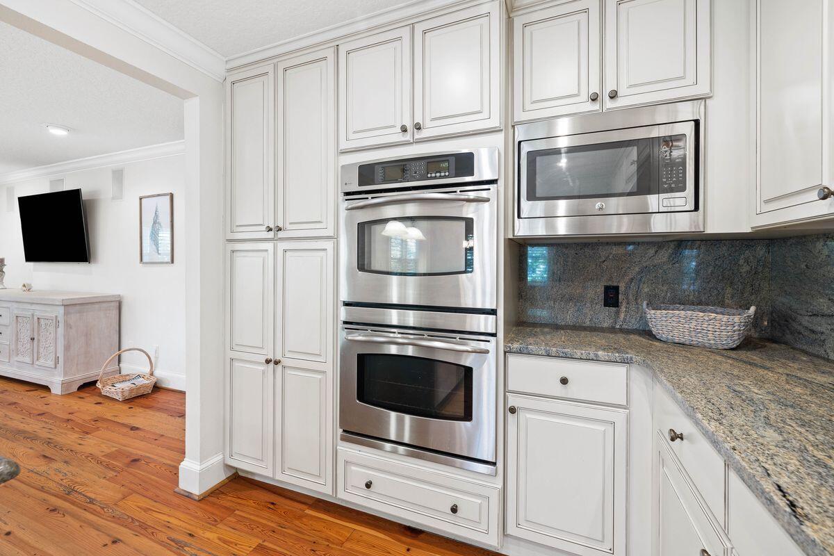 141 Crescent Road Santa Rosa Beach, FL 32459 - Photo 10 of 40 a kitchen with granite countertop white cabinets and appliances