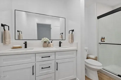 a bathroom with a sink a toilet and mirror