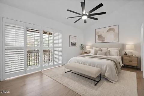 a spacious bedroom with a large bed and a large window