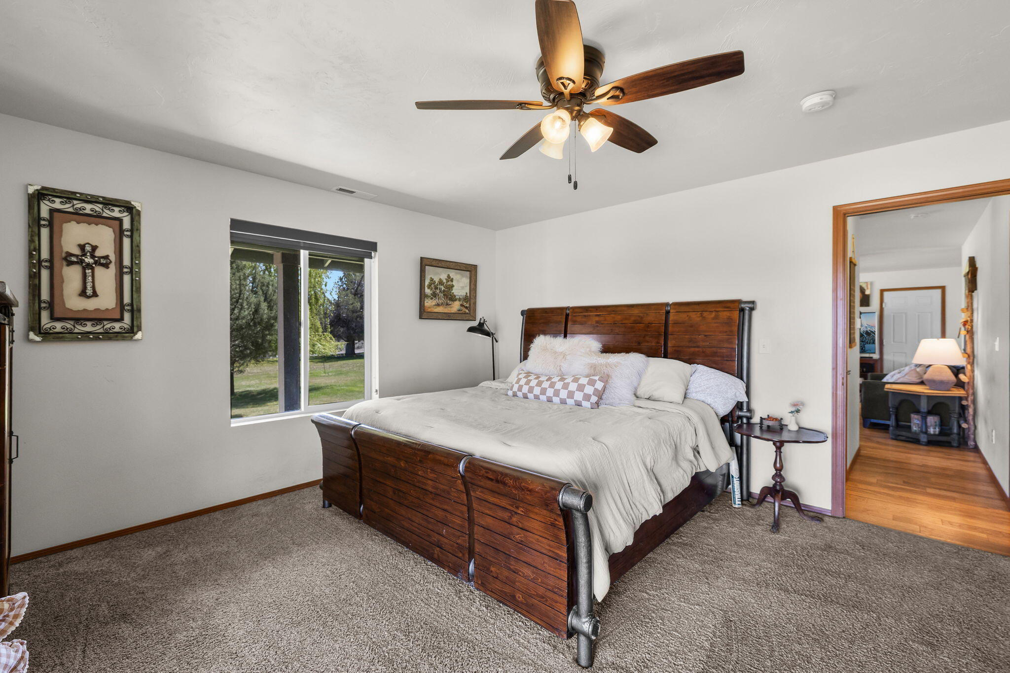 63639 Gentry Loop Bend, OR 97701 - Photo 18 of 40 a bedroom with a bed a window and a chandelier