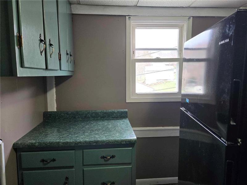 104 Forrest Street Petrolia, PA 16050 - Photo 17 of 22 a kitchen with a granite countertop sink and a window