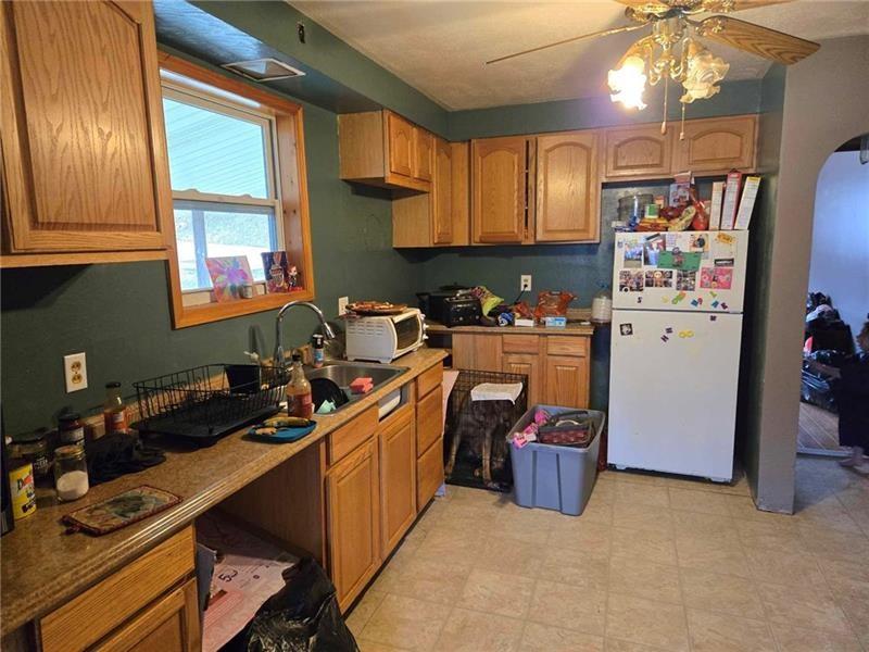 104 Forrest Street Petrolia, PA 16050 - Photo 6 of 22 a kitchen with stainless steel appliances a sink stove and refrigerator