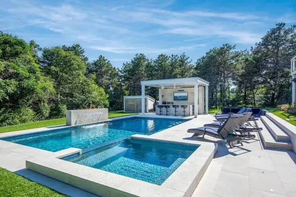 a view of a house with backyard porch and sitting area