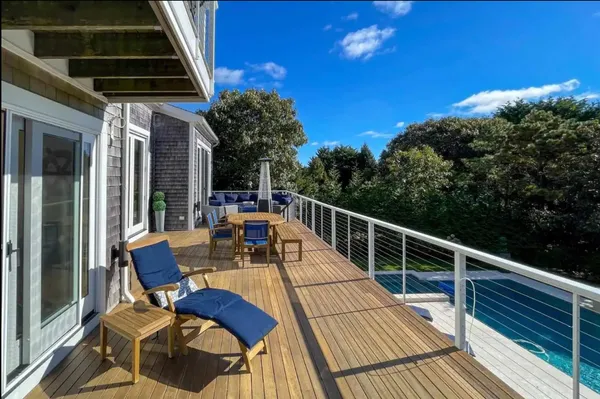 a view of a chairs and table in the back yard of the house