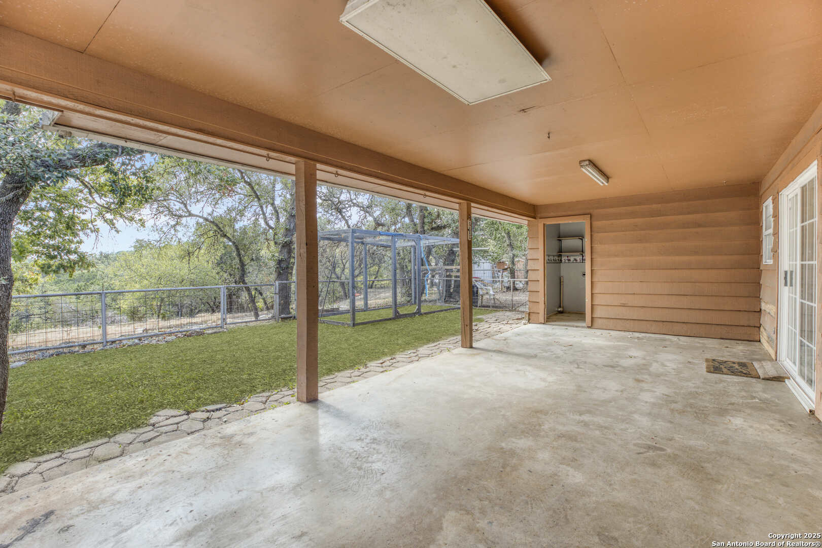 2019 North Park Road Canyon Lake, TX 78133 - Photo 20 of 22 a view of an empty room with a large window and yard