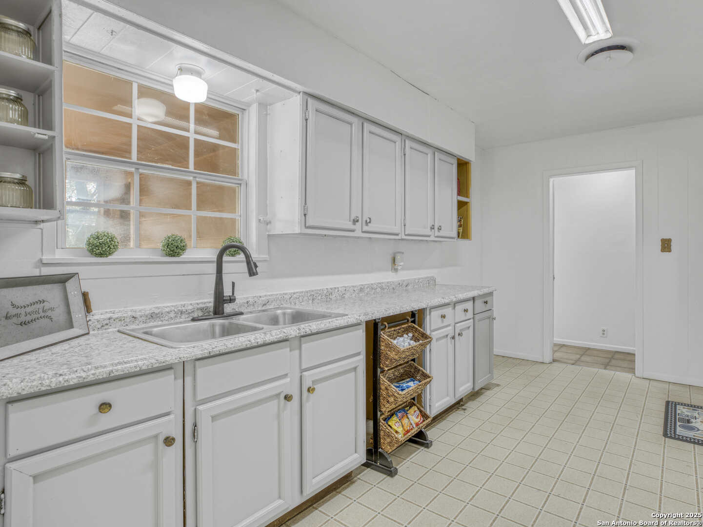 2019 North Park Road Canyon Lake, TX 78133 - Photo 7 of 22 a kitchen with stainless steel appliances granite countertop a sink and a white cabinets