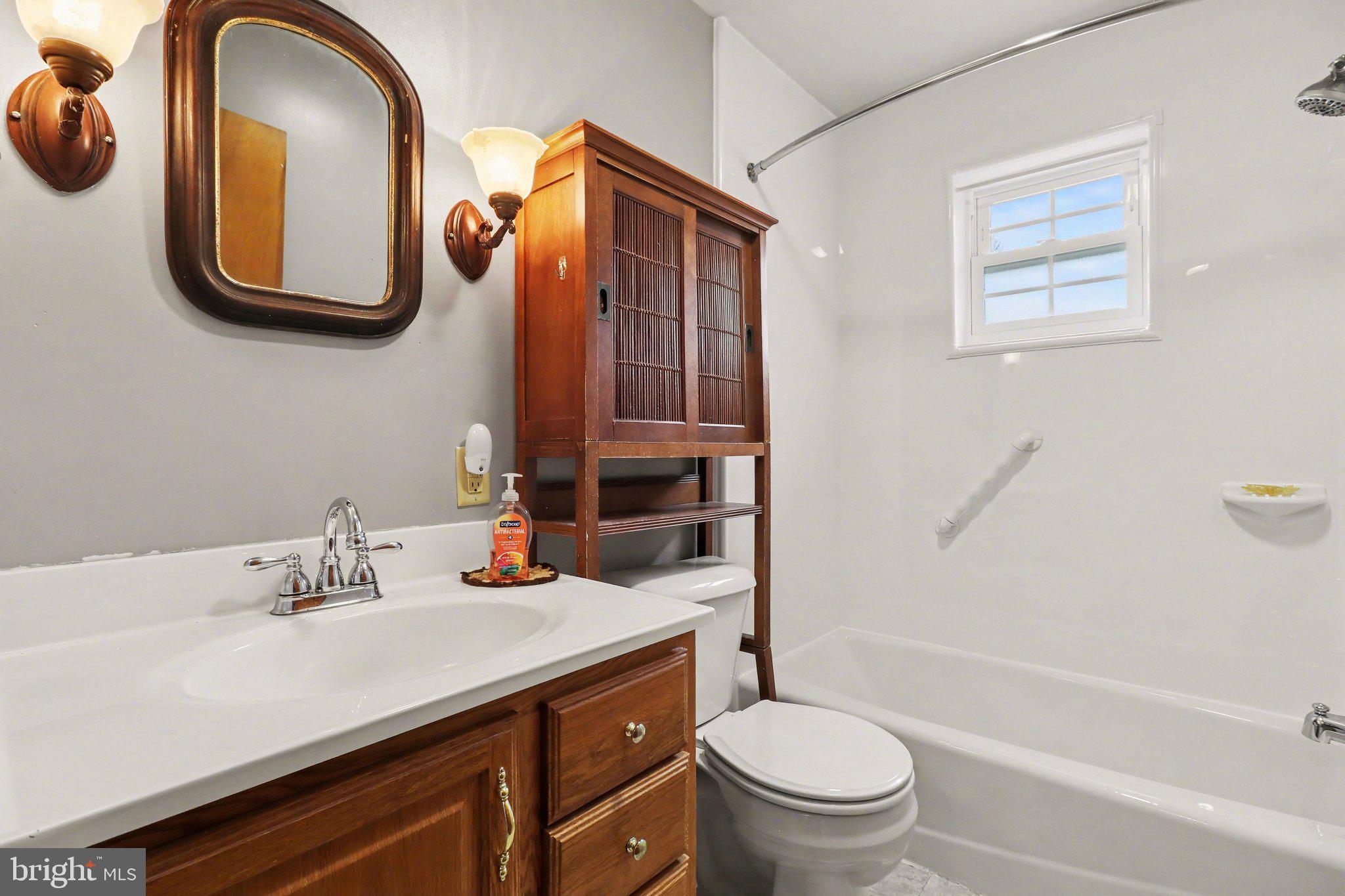 3606 Bonnyview Road Harrisburg, PA 17109 - Photo 13 of 34 a bathroom with a sink a toilet and a mirror