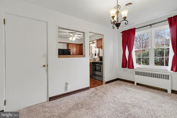a view of a livingroom with wooden floor and chandelier