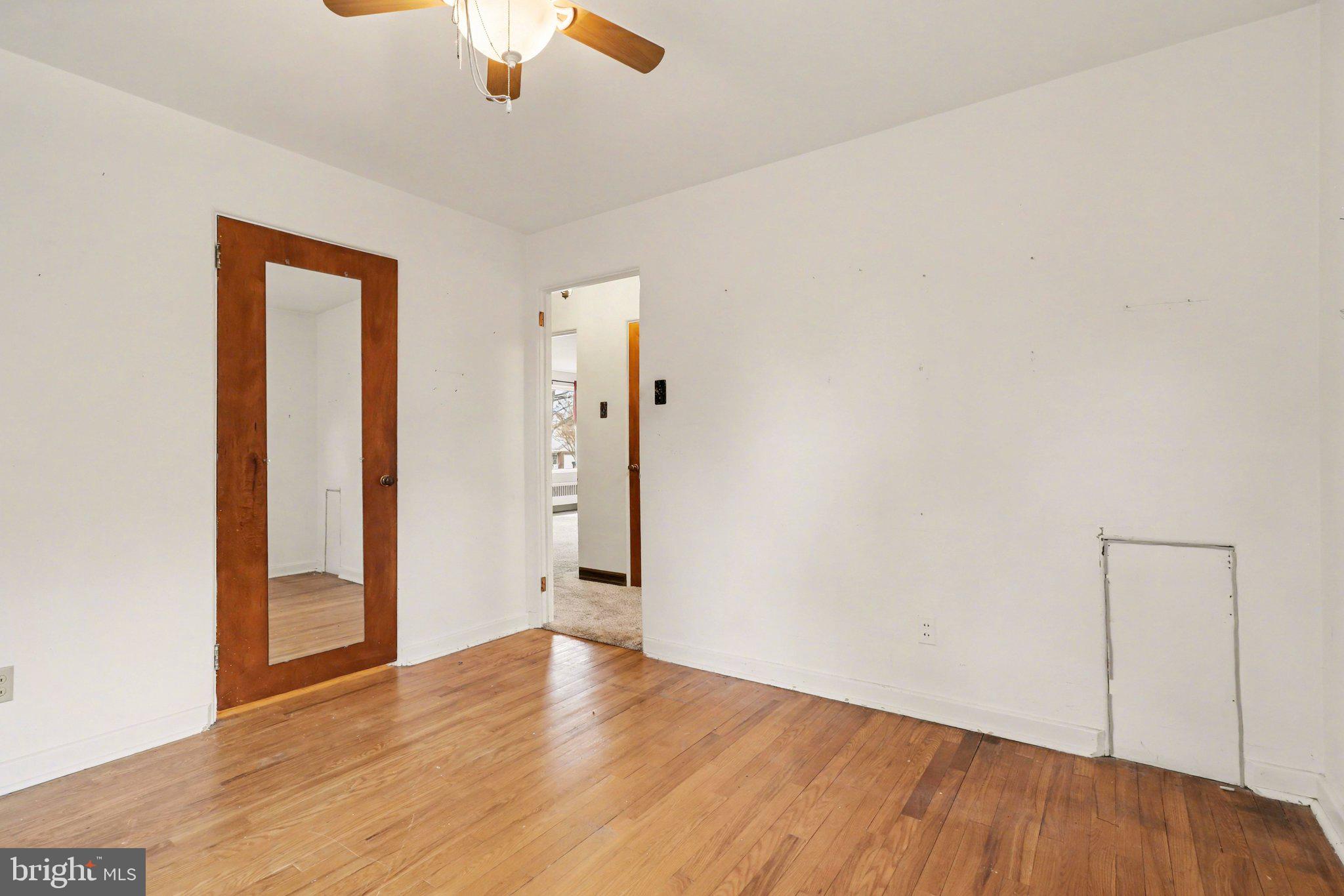 3606 Bonnyview Road Harrisburg, PA 17109 - Photo 10 of 34 an empty room with wooden floor cabinet and windows