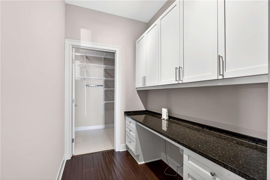 201 West Ponce De Leon Avenue, Unit 702 Decatur, GA 30030 - Photo 21 of 41 a kitchen with granite countertop white cabinets and sink