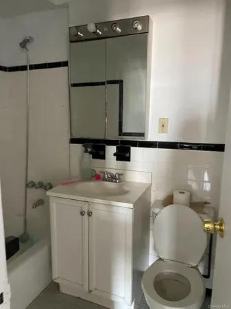 a bathroom with a sink toilet and mirror