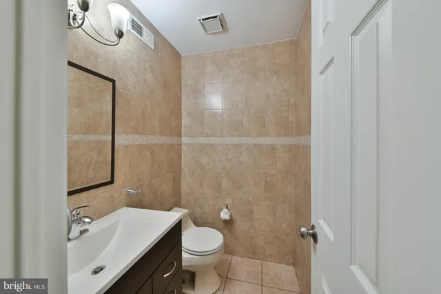 a bathroom with a sink a toilet and a mirror