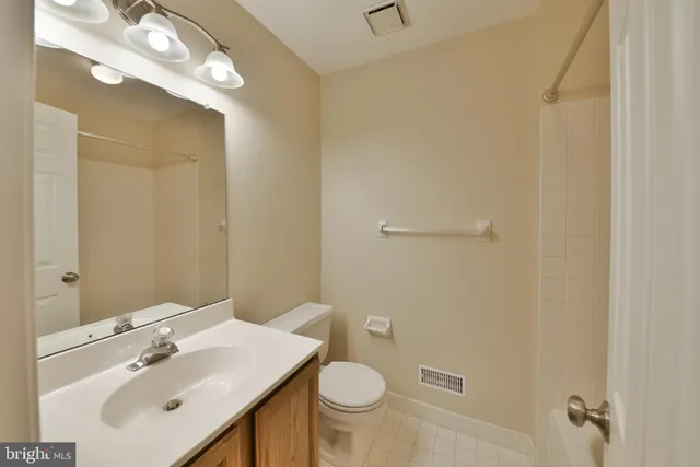 a bathroom with a sink toilet and vanity